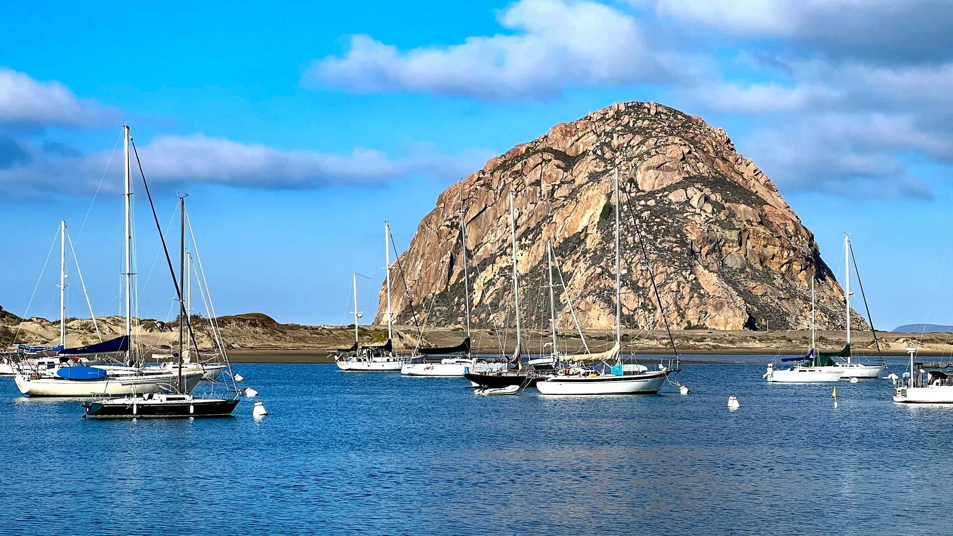 Sailboats moored in front of Morro Rock, Morro Bay